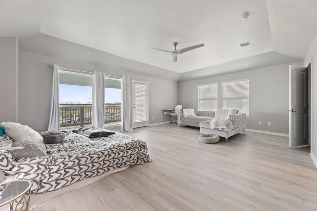 a spacious bedroom with a bed couch and a large window
