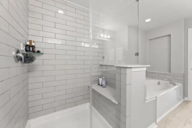 a bathroom with a bathtub and shower