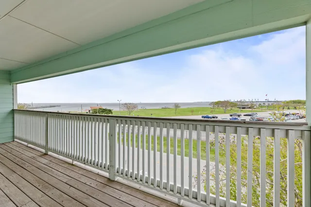 a view of city and ocean from a balcony