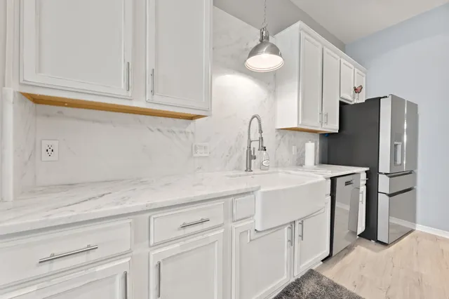 a kitchen with appliances a sink and cabinets