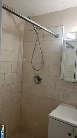 a bathroom with a shower and a sink