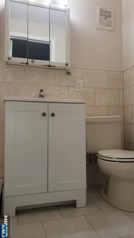 a bathroom with a sink a toilet and mirror