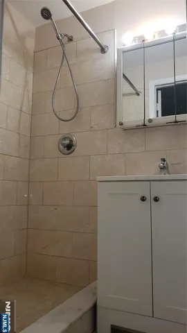 a bathroom with a shower and a sink