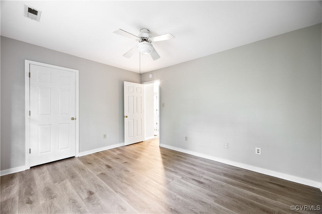 3012 Appleford Drive Chester, VA 23831 - Photo 12 of 25 an empty room with wooden floor fan and windows