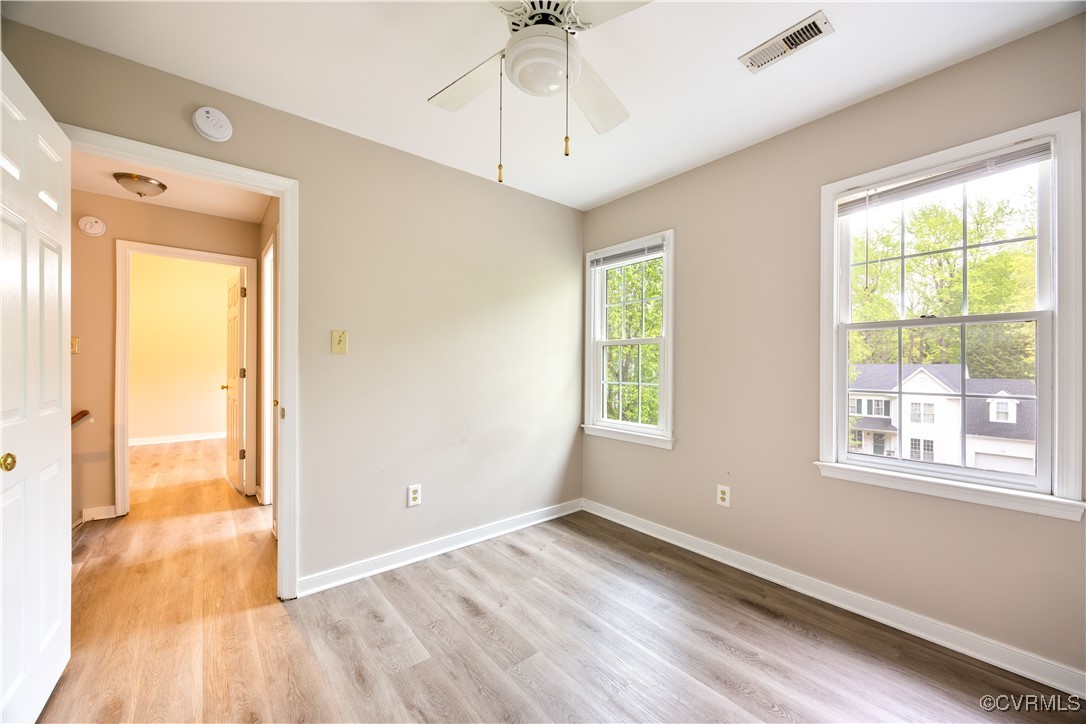 3012 Appleford Drive Chester, VA 23831 - Photo 16 of 25 a view of an empty room with wooden floor and a window