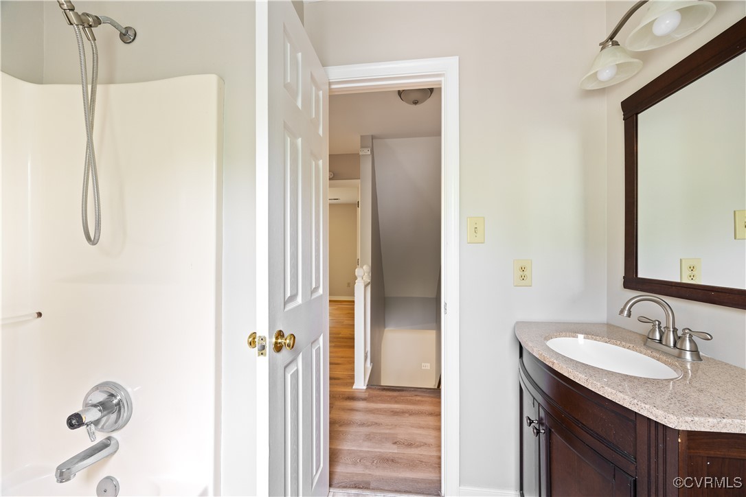 3012 Appleford Drive Chester, VA 23831 - Photo 17 of 25 a bathroom with a granite countertop sink a mirror and a shower