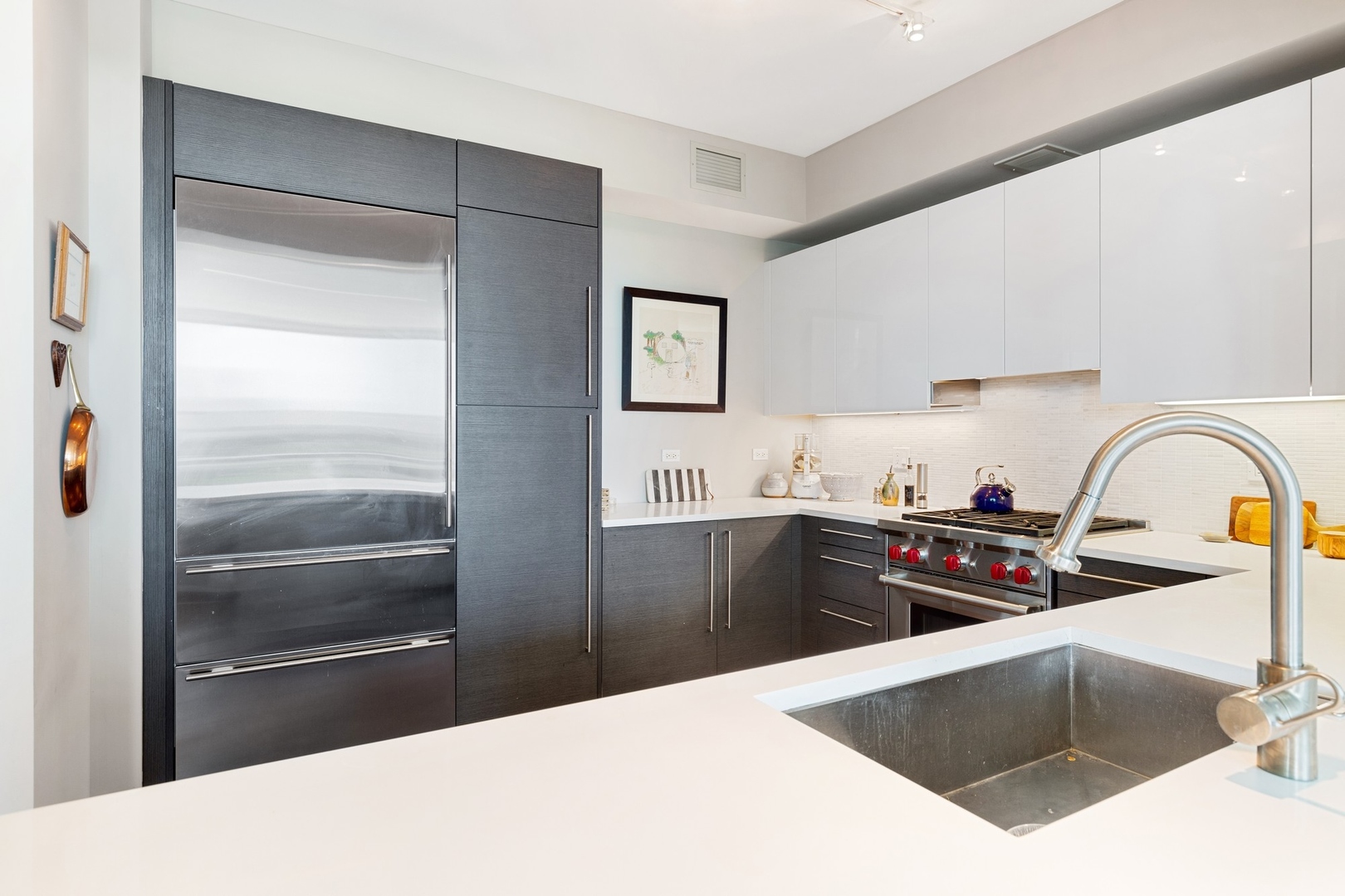 1201 South Prairie Avenue, Unit 805 Chicago, IL 60605 - Photo 10 of 23 a kitchen with stainless steel appliances kitchen island granite countertop a refrigerator and a sink