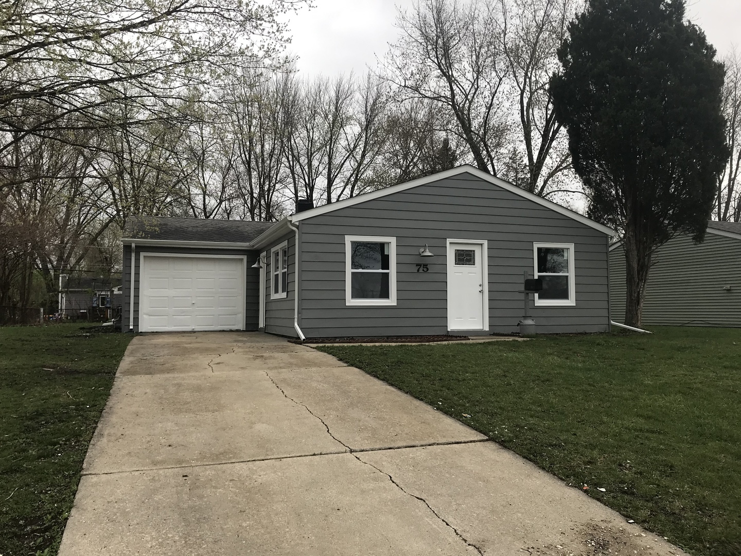 75 Saugatuck Road Montgomery, IL 60538 - Photo 1 of 22 a front view of a house with a garden