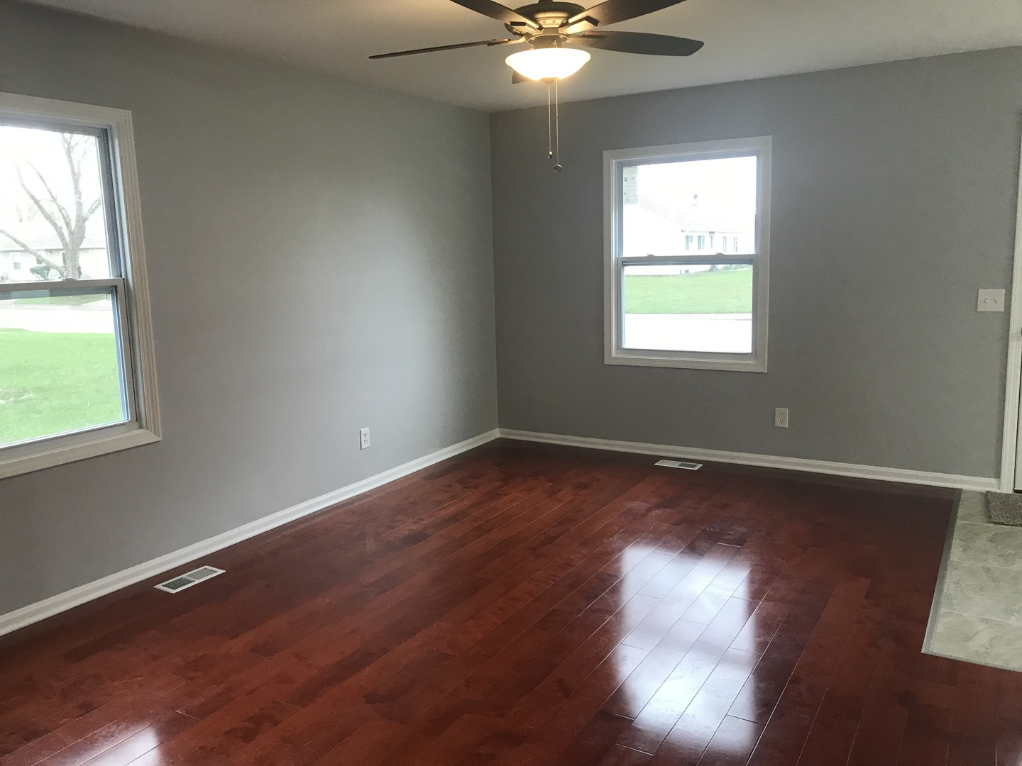 75 Saugatuck Road Montgomery, IL 60538 - Photo 2 of 22 an empty room with wooden floor and windows
