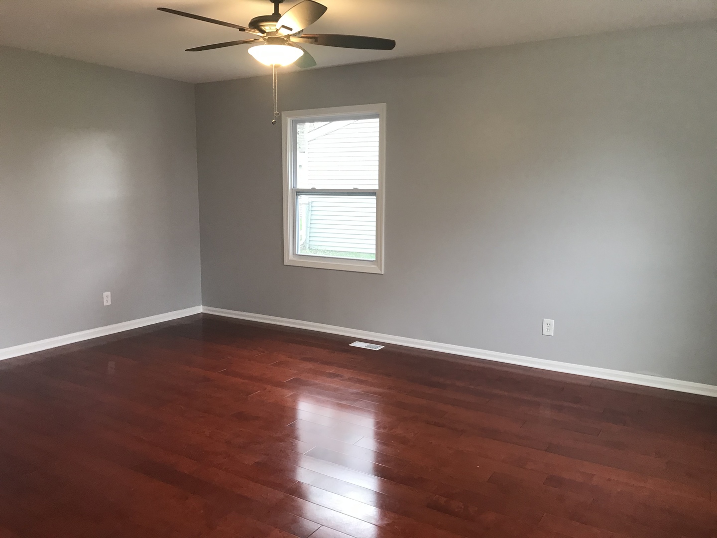 75 Saugatuck Road Montgomery, IL 60538 - Photo 3 of 22 a view of an empty room with wooden floor and a window