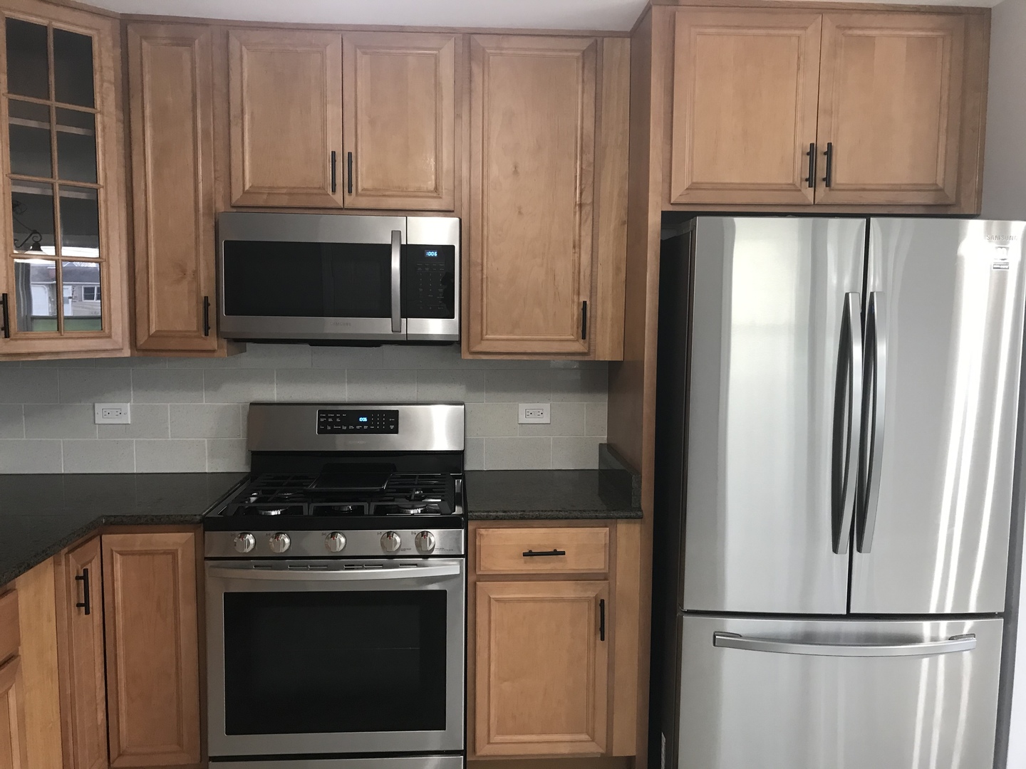75 Saugatuck Road Montgomery, IL 60538 - Photo 4 of 22 a kitchen with refrigerator a microwave and cabinets