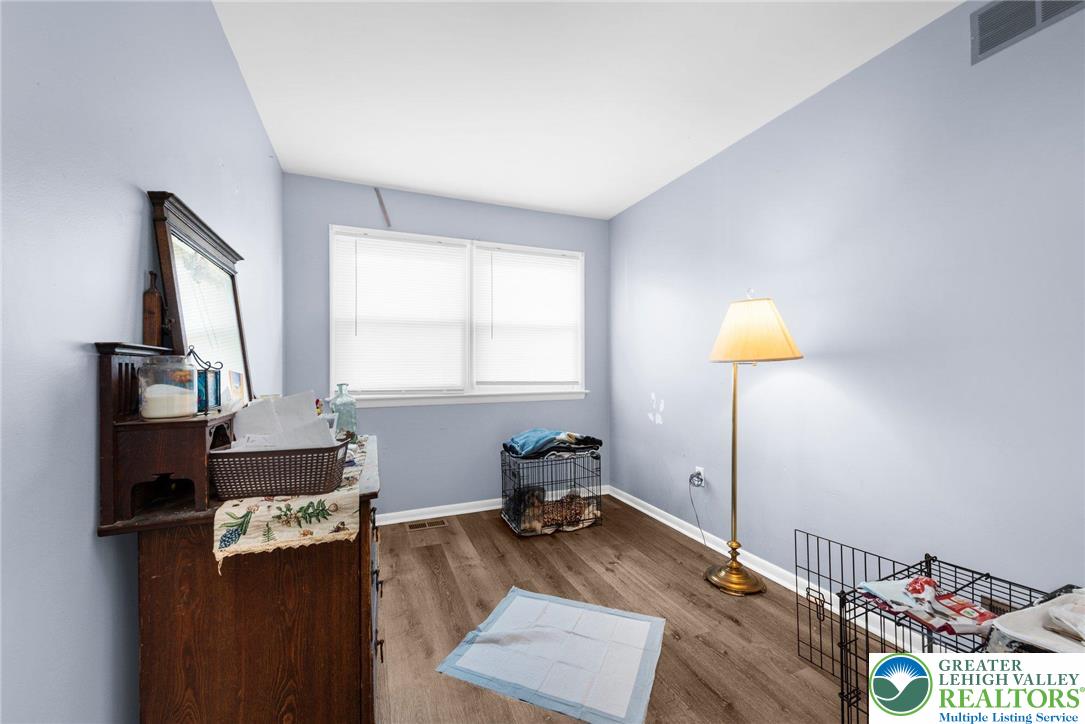 935 Marion Street Bethlehem, PA 18017 - Photo 12 of 20 a bedroom with a bed and a lamp on table