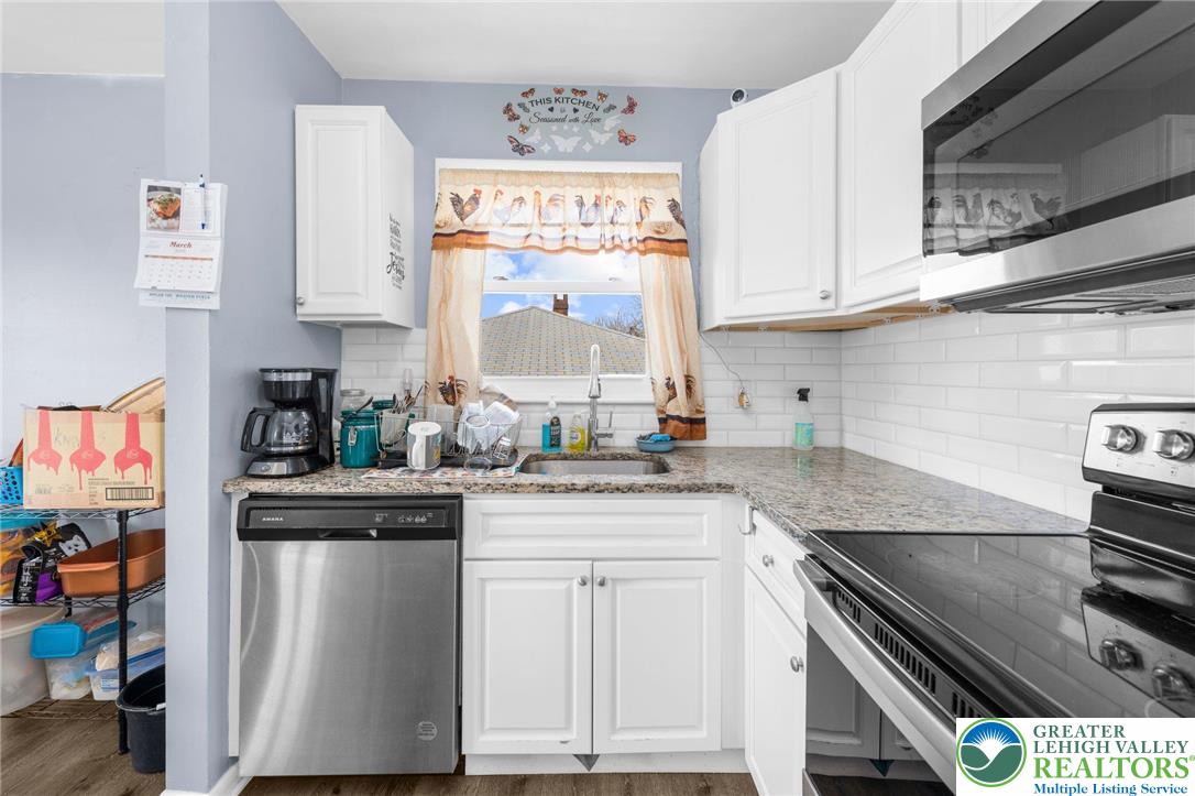 935 Marion Street Bethlehem, PA 18017 - Photo 6 of 20 a kitchen with stainless steel appliances granite countertop a stove and a sink