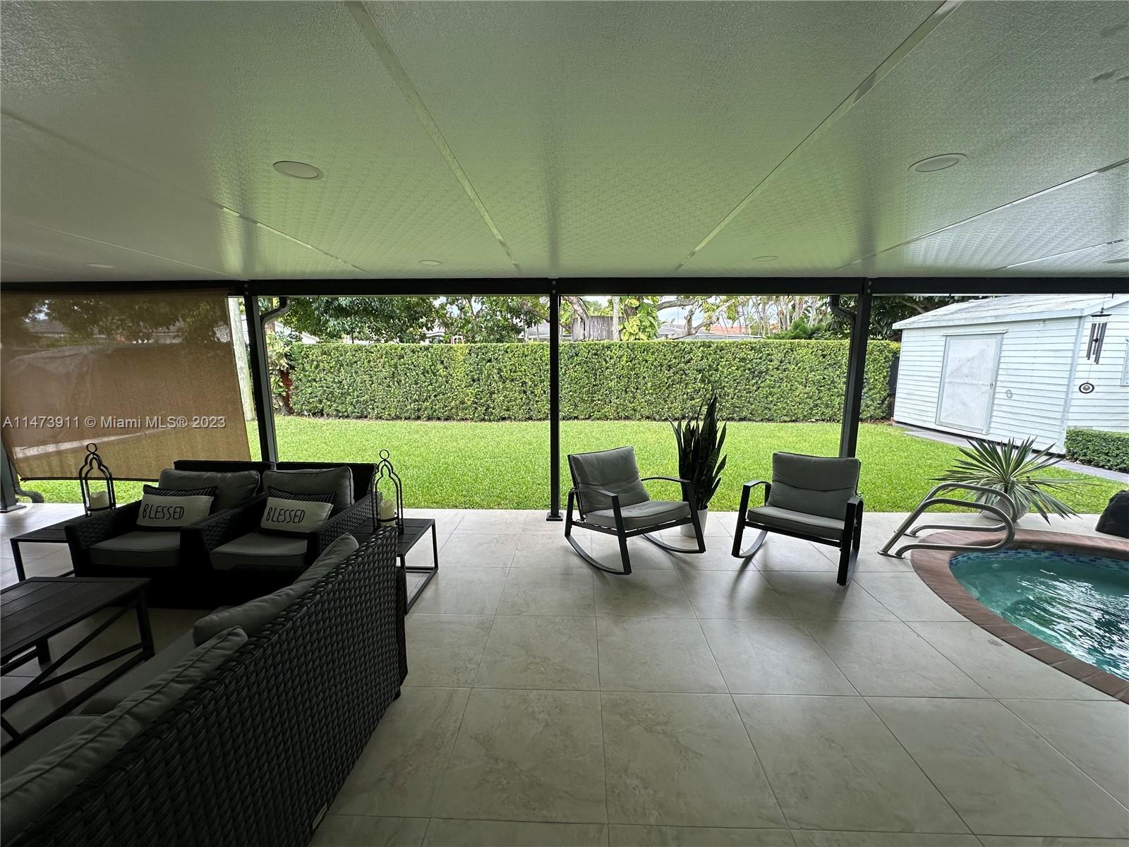 4610 Southwest 89th Place Miami, FL 33165 - Photo 11 of 52 a living room with furniture and a floor to ceiling window