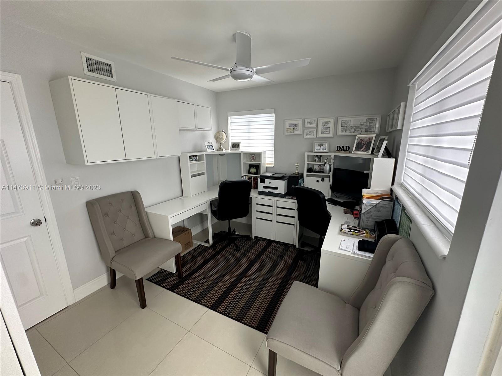 4610 Southwest 89th Place Miami, FL 33165 - Photo 14 of 52 a living room with furniture a fireplace and a window