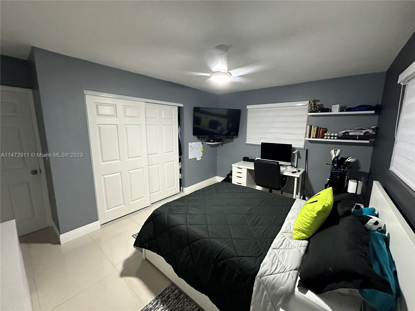 4610 Southwest 89th Place Miami, FL 33165 - Photo 16 of 52 a bedroom with a bed and a walk in closet