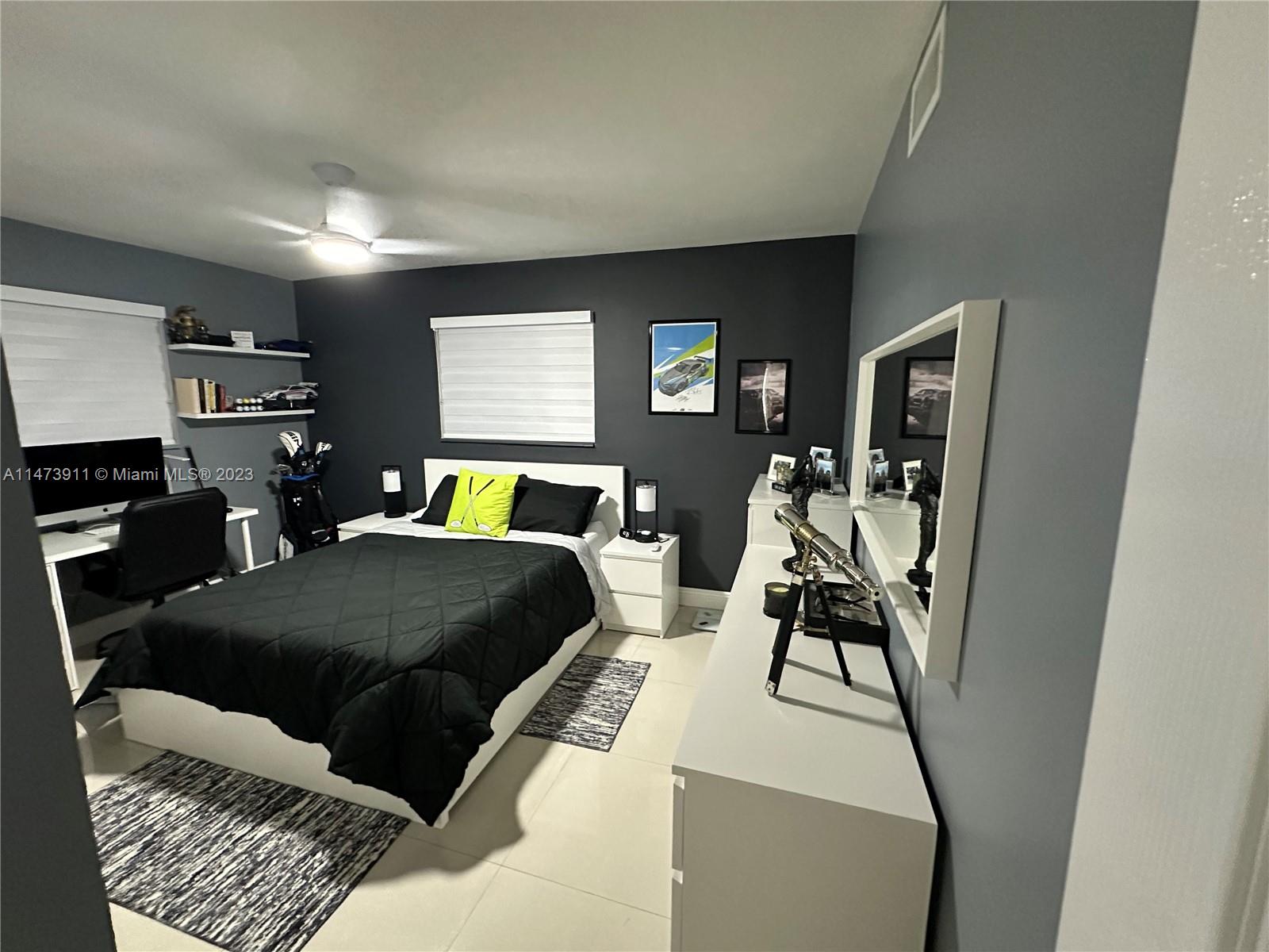 4610 Southwest 89th Place Miami, FL 33165 - Photo 17 of 52 a bedroom with a bed and wooden floor