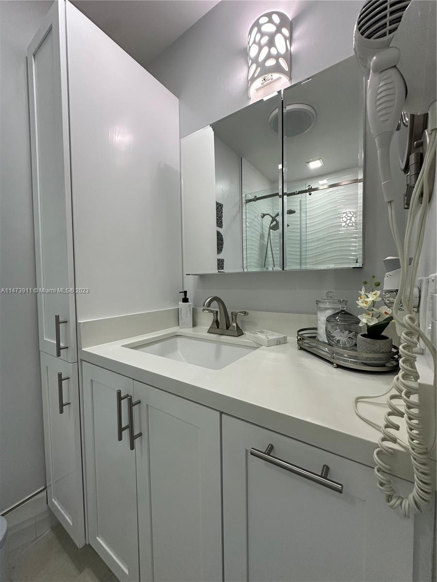 4610 Southwest 89th Place Miami, FL 33165 - Photo 20 of 52 a bathroom with a sink and a mirror