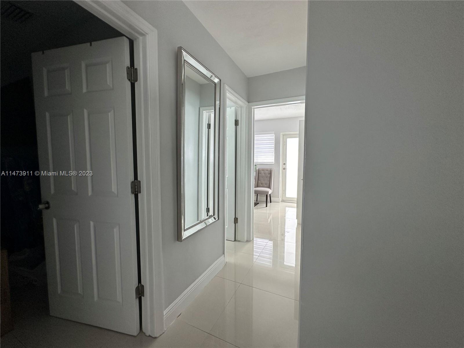 4610 Southwest 89th Place Miami, FL 33165 - Photo 2 of 52 a view of a bathroom from a hallway