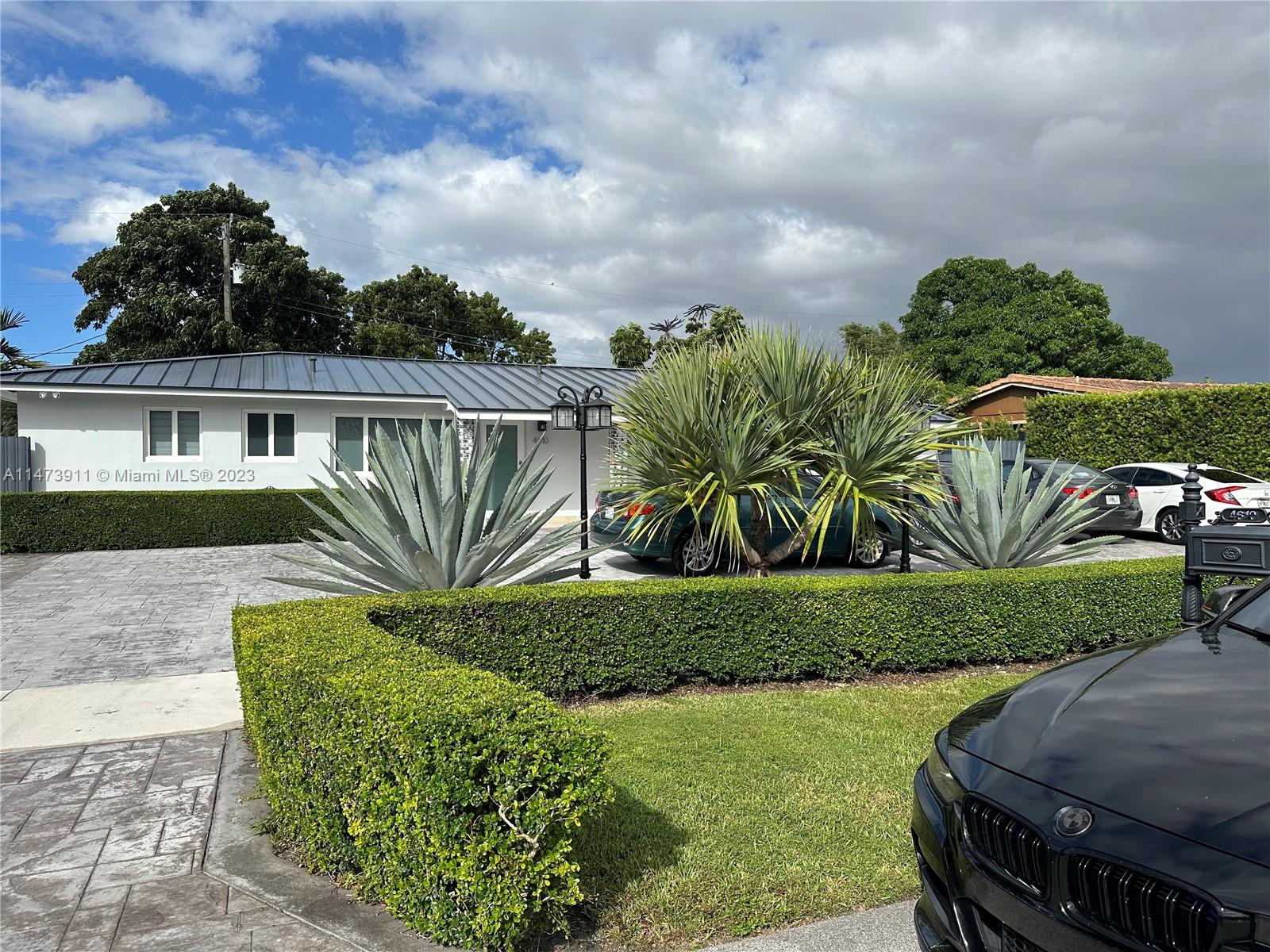4610 Southwest 89th Place Miami, FL 33165 - Photo 29 of 52 a view of a garden with a bench in a garden