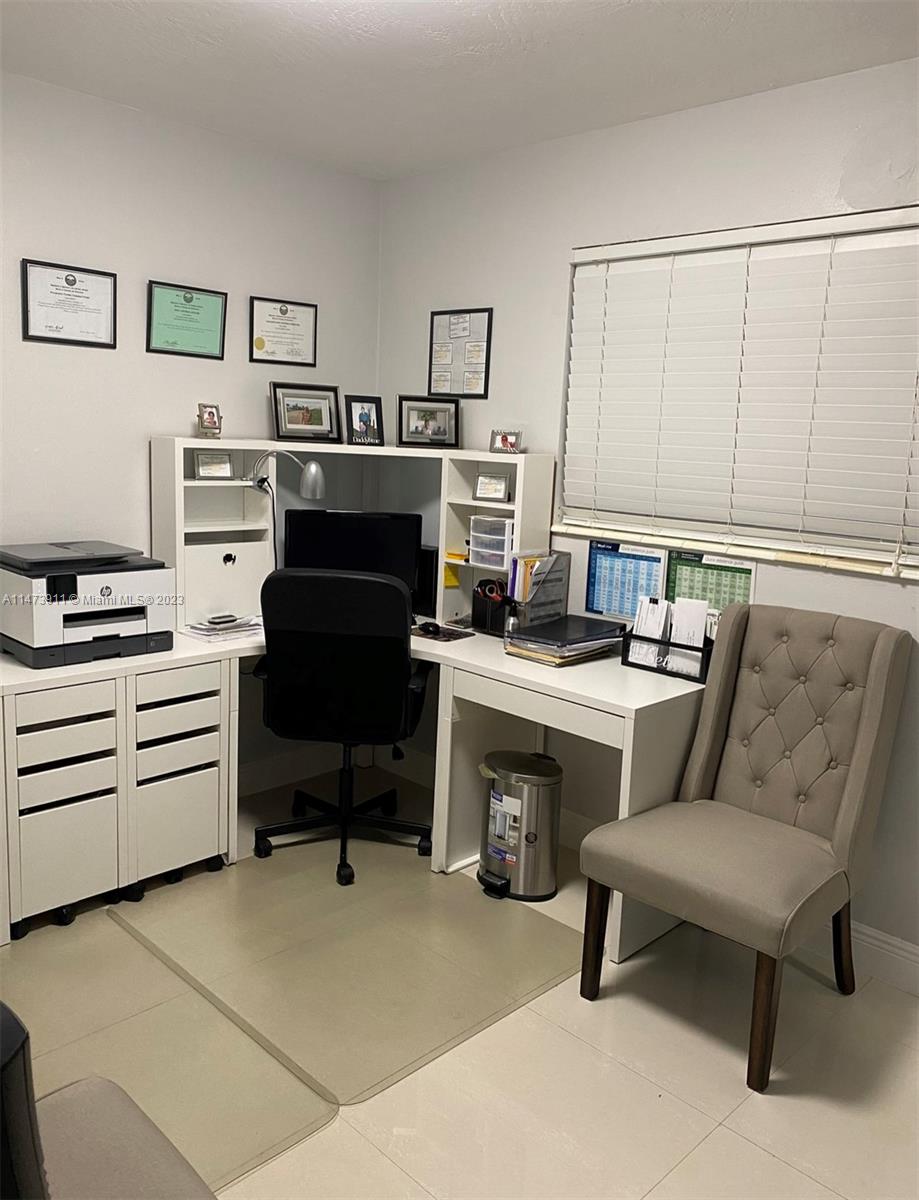 4610 Southwest 89th Place Miami, FL 33165 - Photo 3 of 52 a room with furniture a piano and a bookshelf