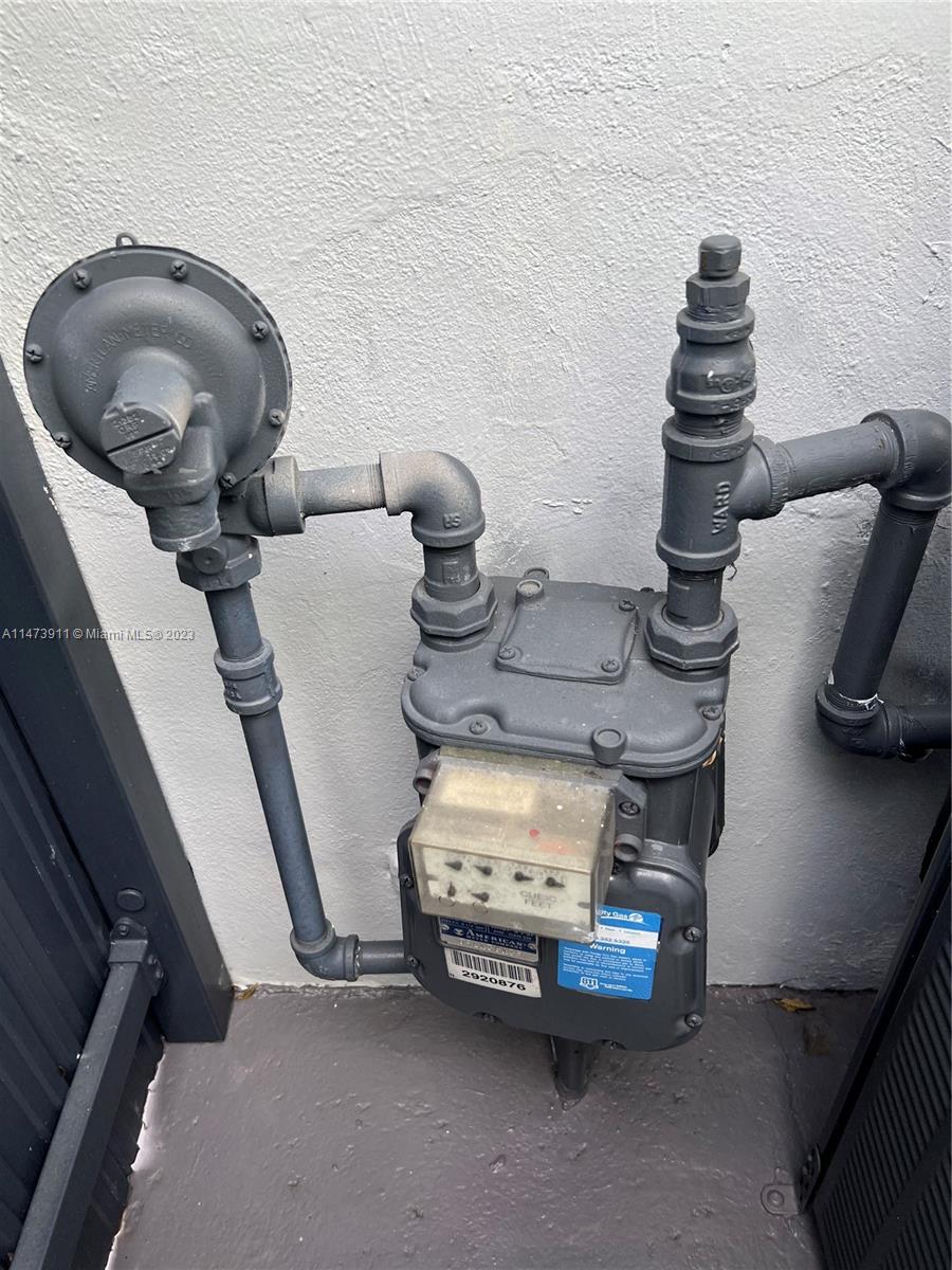 4610 Southwest 89th Place Miami, FL 33165 - Photo 35 of 52 a water heater room with wooden floor