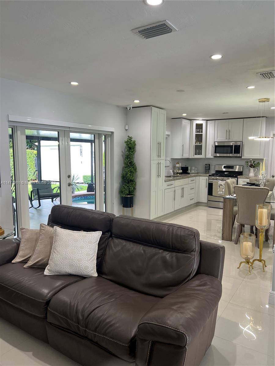 4610 Southwest 89th Place Miami, FL 33165 - Photo 40 of 52 a living room with furniture and a large window