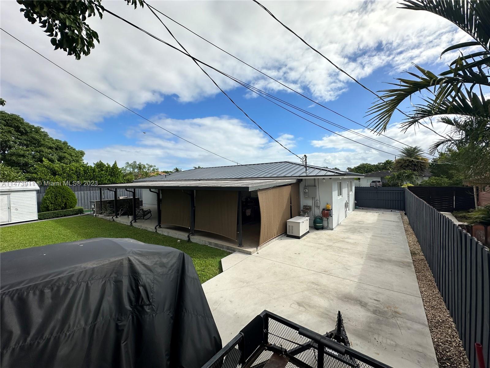 4610 Southwest 89th Place Miami, FL 33165 - Photo 4 of 52 a view of a backyard with furniture and a cabin