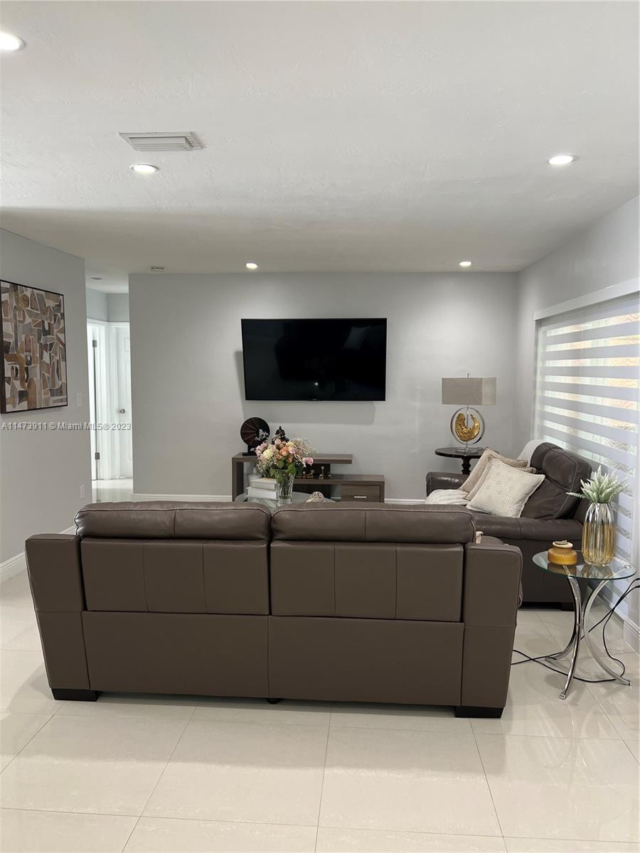 4610 Southwest 89th Place Miami, FL 33165 - Photo 42 of 52 a living room with furniture and a flat screen tv