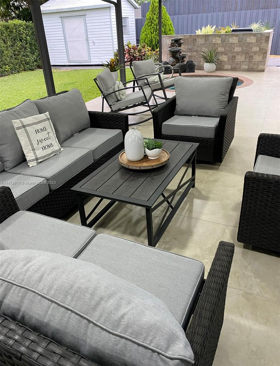 4610 Southwest 89th Place Miami, FL 33165 - Photo 52 of 52 a living room with furniture and a lamp