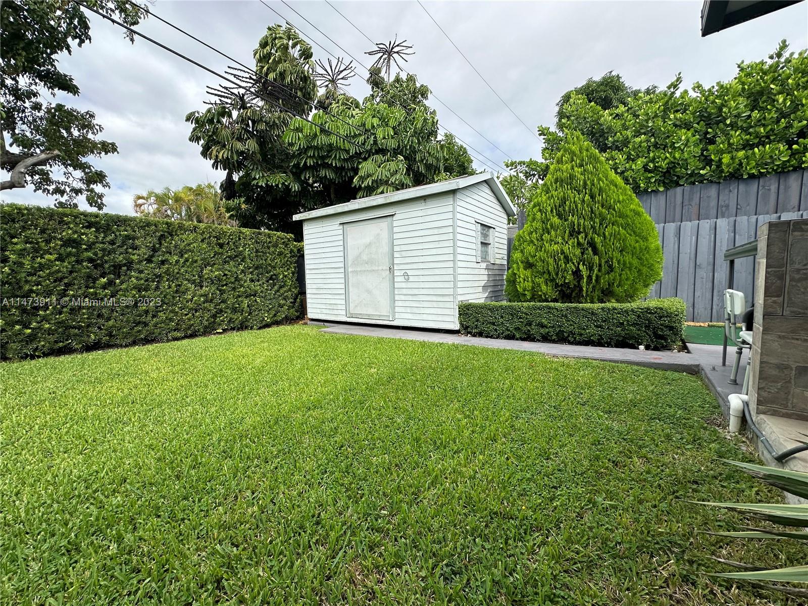 4610 Southwest 89th Place Miami, FL 33165 - Photo 6 of 52 a view of a backyard with large trees plants and large tree