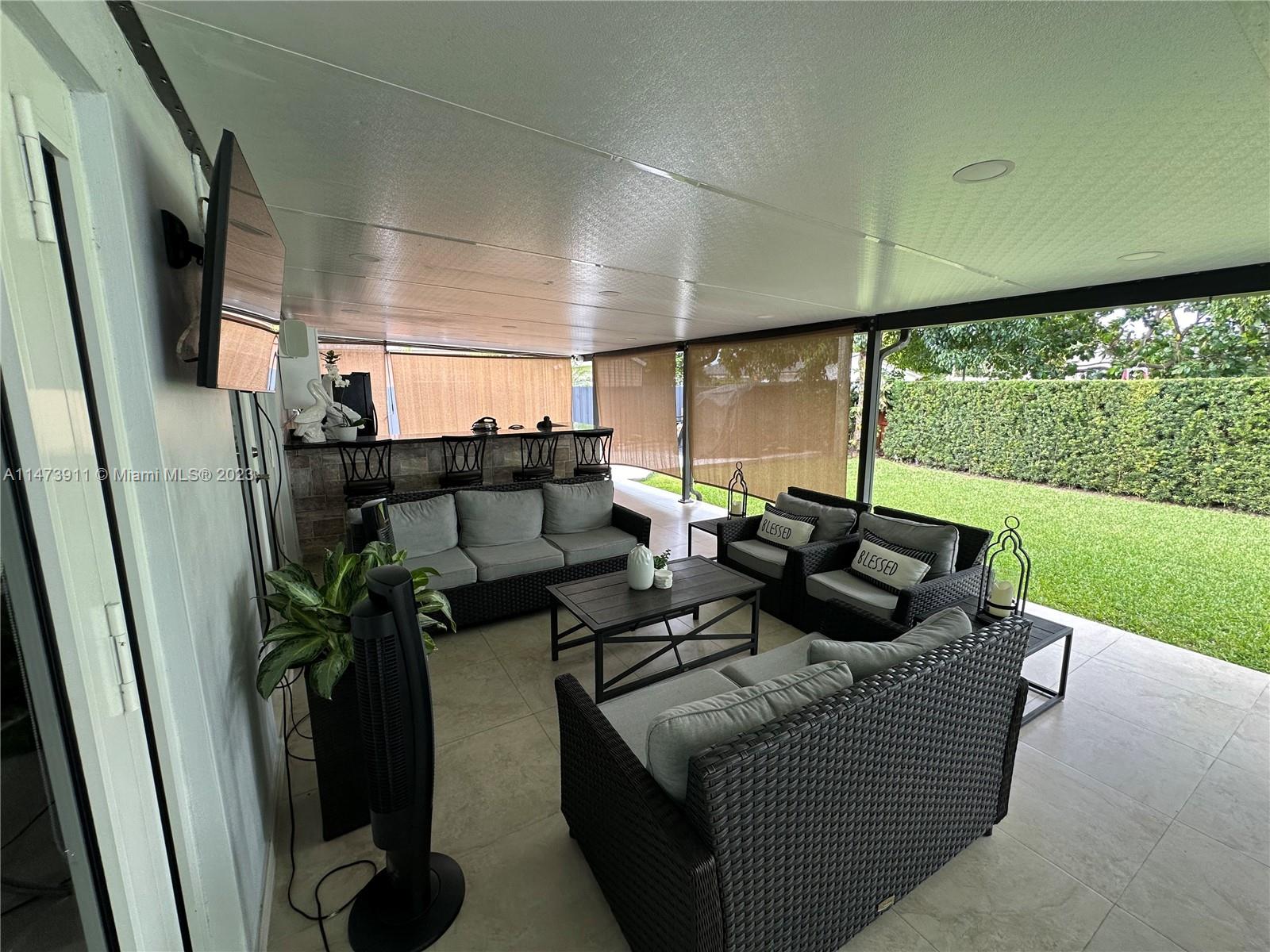 4610 Southwest 89th Place Miami, FL 33165 - Photo 10 of 52 a living room with furniture floor to ceiling window and a fireplace