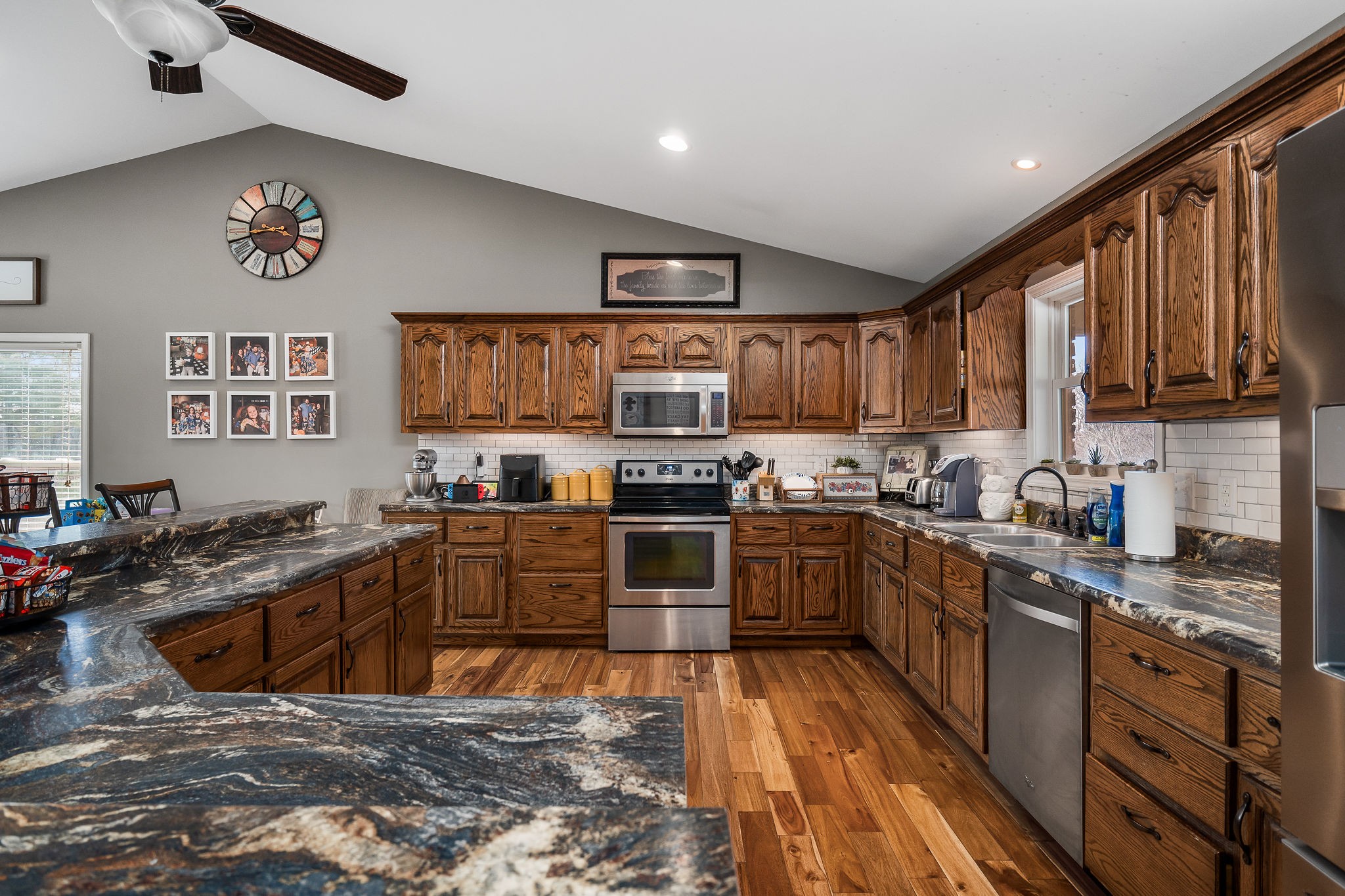 14525 Tucker Ridge Road Silver Point, TN 38582 - Photo 22 of 64 a kitchen with stainless steel appliances granite countertop a stove top oven a sink dishwasher a dining table and chairs with wooden floor