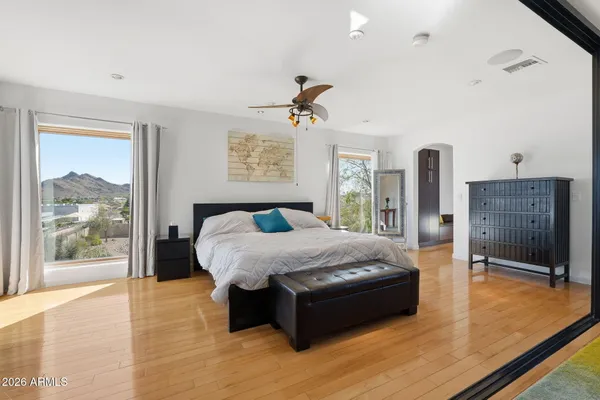 a bedroom with a bed chandelier and a window