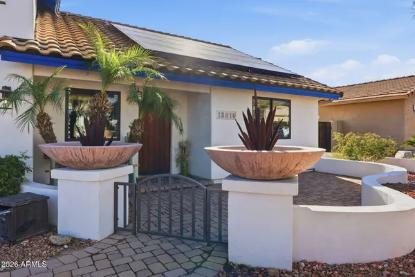 a view of a patio with table and chairs