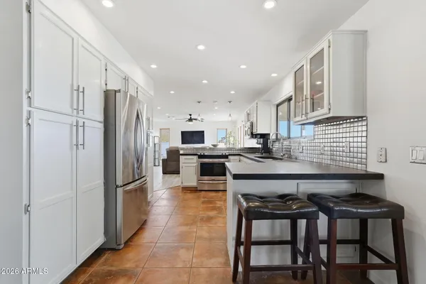 a kitchen with stainless steel appliances granite countertop a stove and a refrigerator