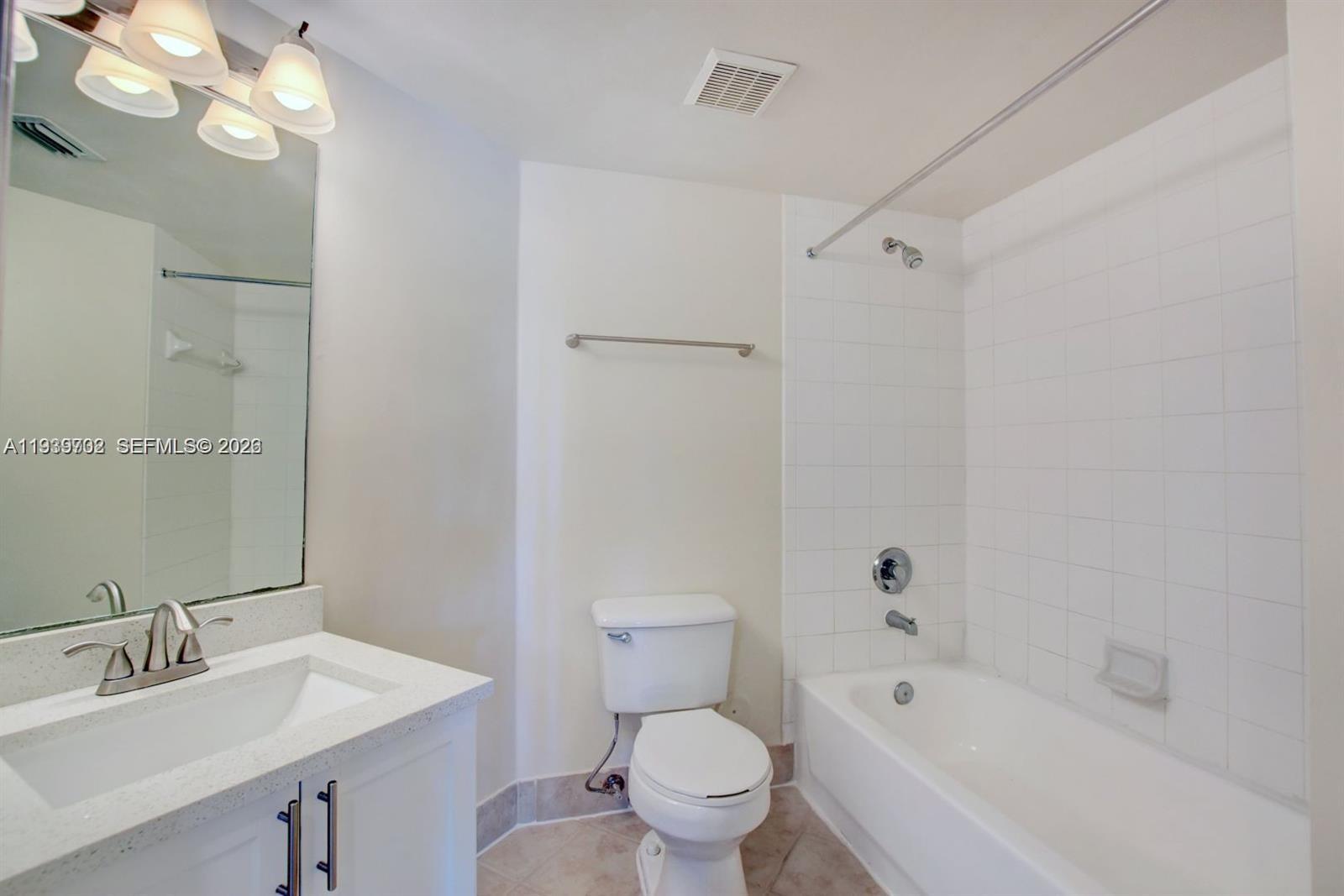 4159 Haverhill Road, Unit 1302 West Palm Beach, FL 33417 - Photo 17 of 19 a bathroom with a sink a toilet and shower