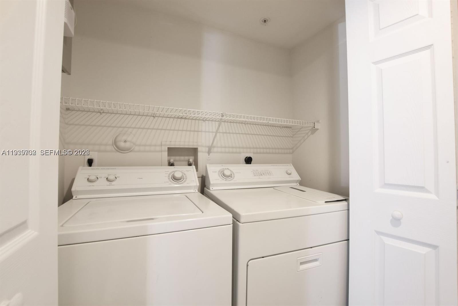 4159 Haverhill Road, Unit 1302 West Palm Beach, FL 33417 - Photo 18 of 19 a utility room with dryer and washer