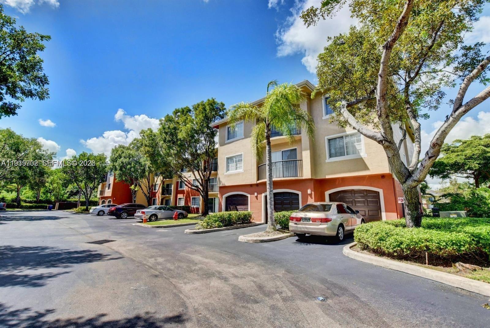 4159 Haverhill Road, Unit 1302 West Palm Beach, FL 33417 - Photo 19 of 19 a front view of a building with cars parked