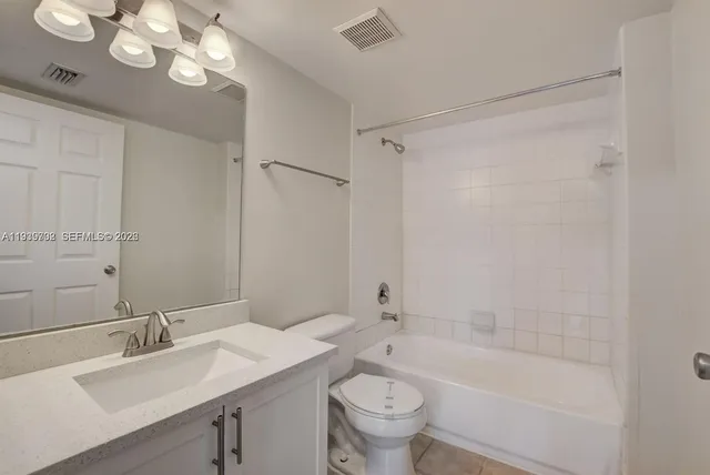 a bathroom with a bathtub a sink a toilet and a mirror