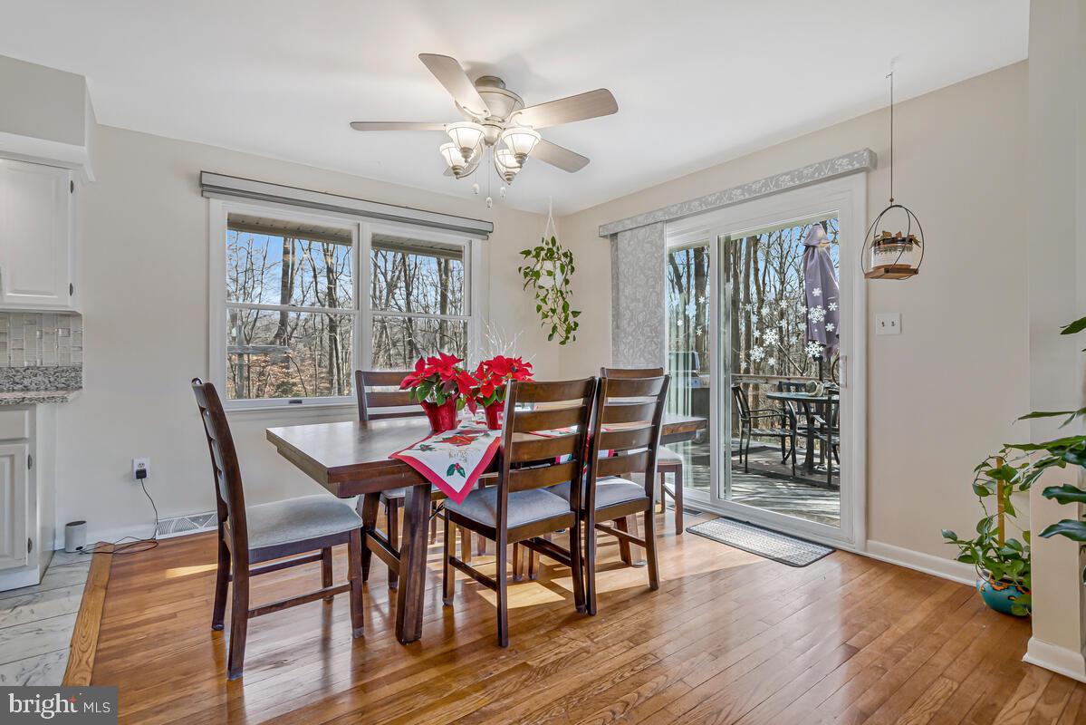 1921 Haven Lane Dunkirk, MD 20754 - Photo 13 of 64 a dining room with furniture a chandelier and wooden floor