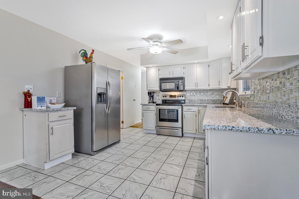 1921 Haven Lane Dunkirk, MD 20754 - Photo 15 of 64 a kitchen with a refrigerator a sink and a stove