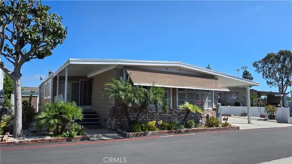 a view of a house with sitting area and potted plants
