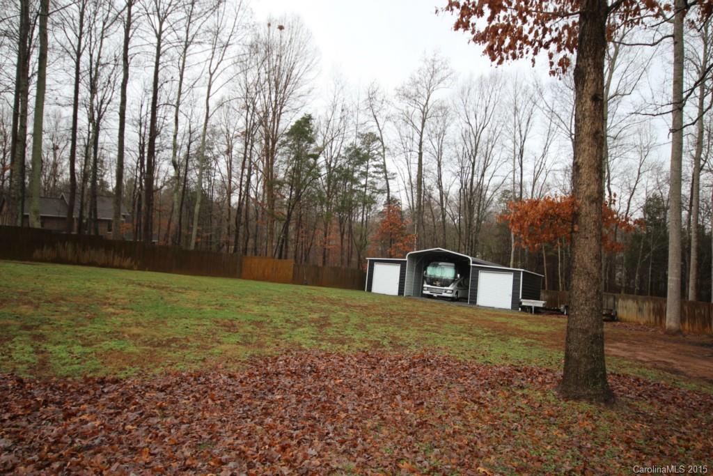 1659 Pine Bluff Court Fort Mill, SC 29708 - Photo 14 of 16 a view of a backyard with large trees