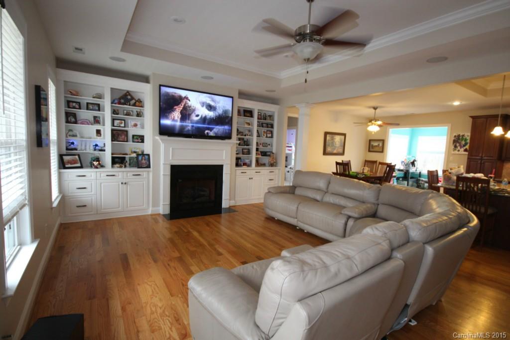 1659 Pine Bluff Court Fort Mill, SC 29708 - Photo 3 of 16 a living room with furniture a fireplace and a flat screen tv