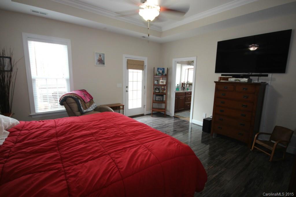1659 Pine Bluff Court Fort Mill, SC 29708 - Photo 7 of 16 a bedroom with a bed and a flat screen tv
