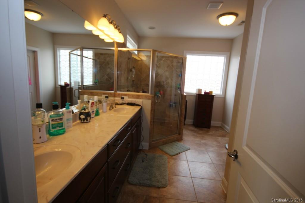 1659 Pine Bluff Court Fort Mill, SC 29708 - Photo 8 of 16 a bathroom with a tub sink and mirror