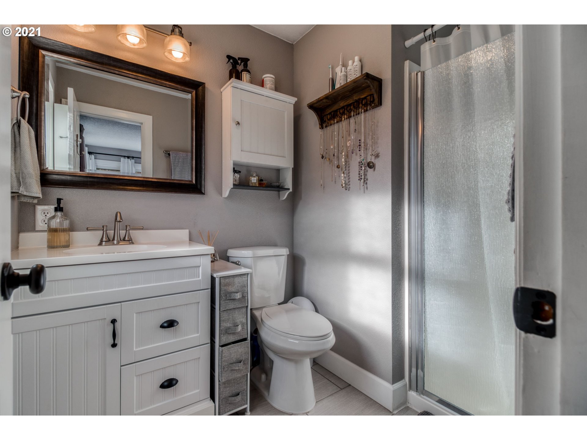 1913 Northeast 199th Street Ridgefield, WA 98642 - Photo 15 of 30 a bathroom with a toilet sink a mirror and shower