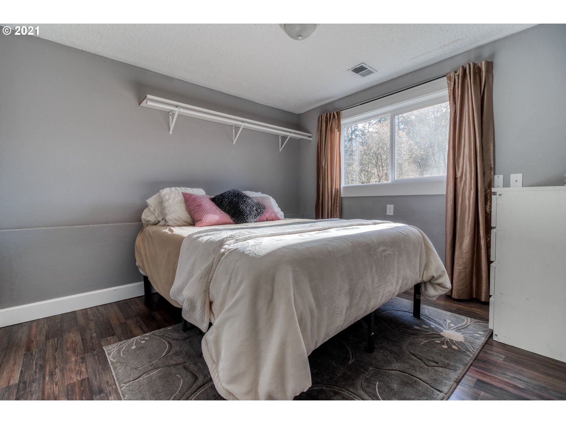 1913 Northeast 199th Street Ridgefield, WA 98642 - Photo 21 of 30 a bedroom with a bed window and wooden floor