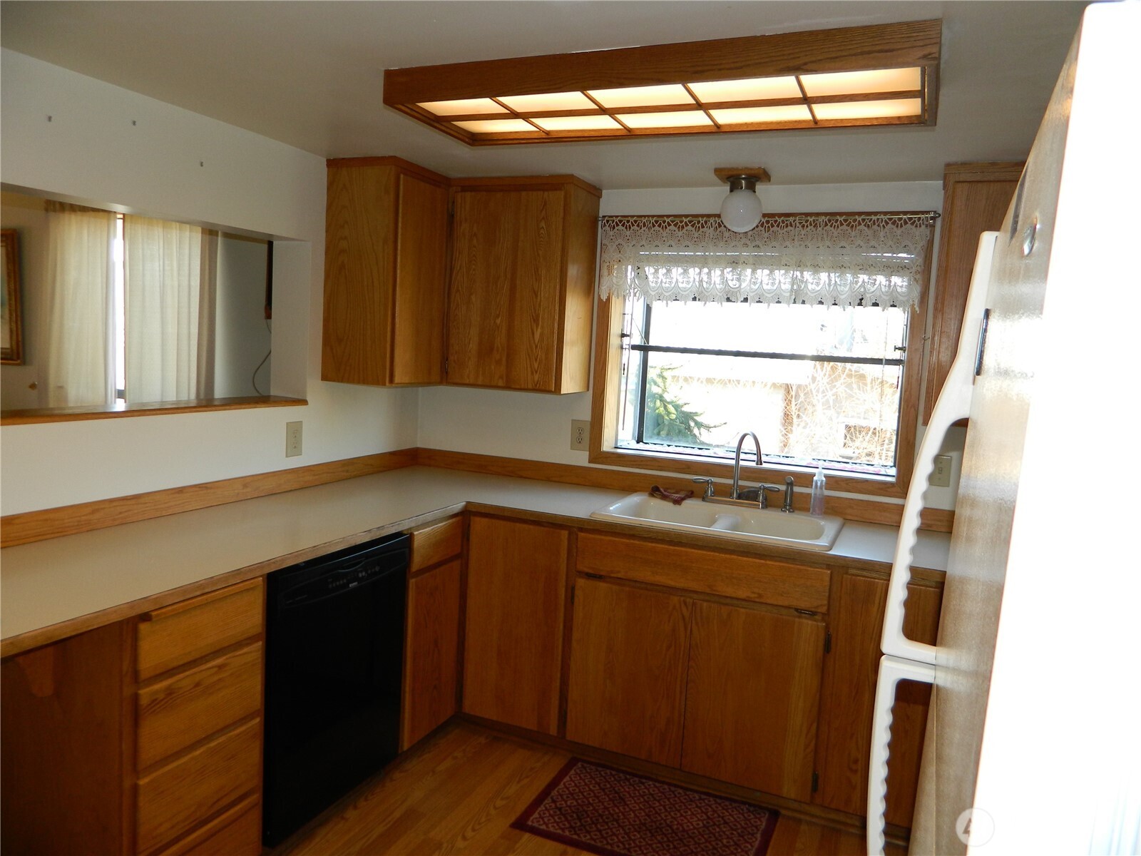 19 3rd Street Tonasket, WA 98855 - Photo 18 of 21 a kitchen with a sink window and cabinets